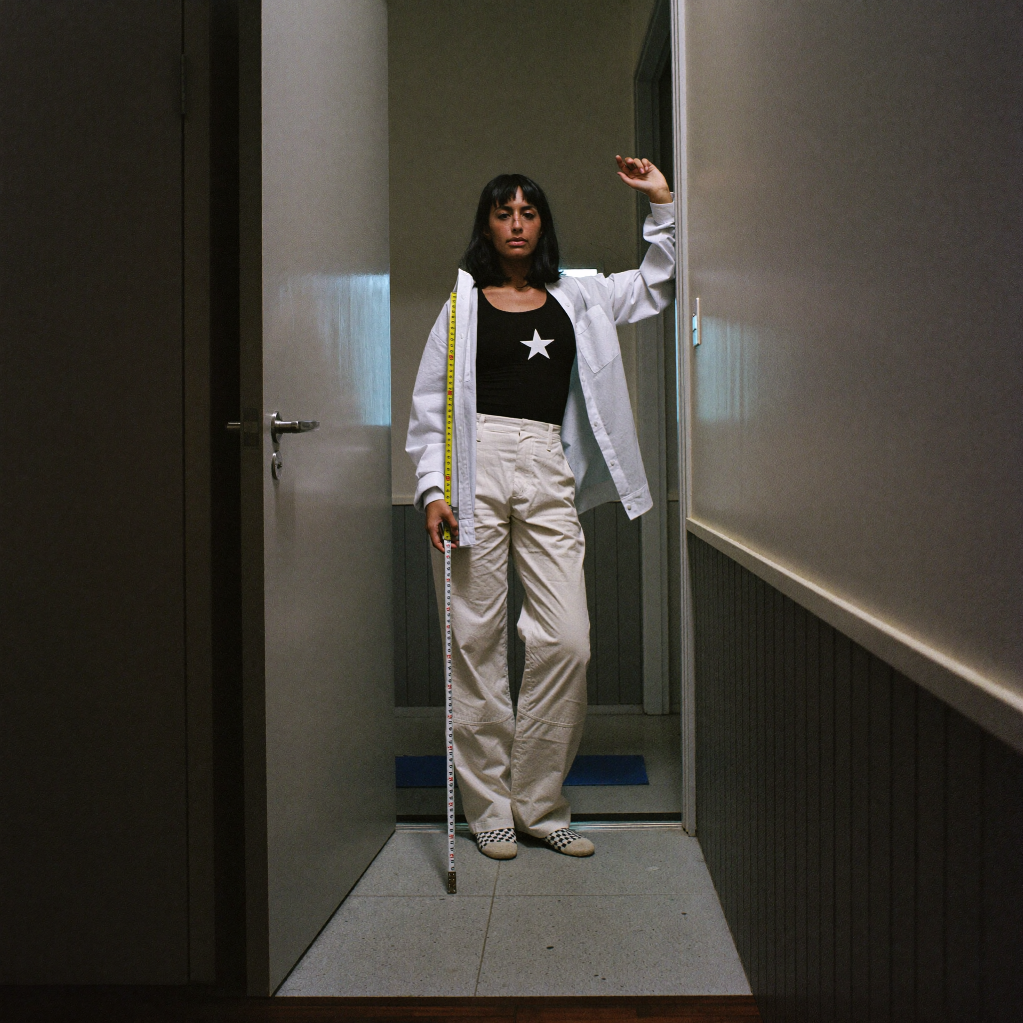 Wide environmental portrait of Mara Johanssen in her 36 sqm apartment